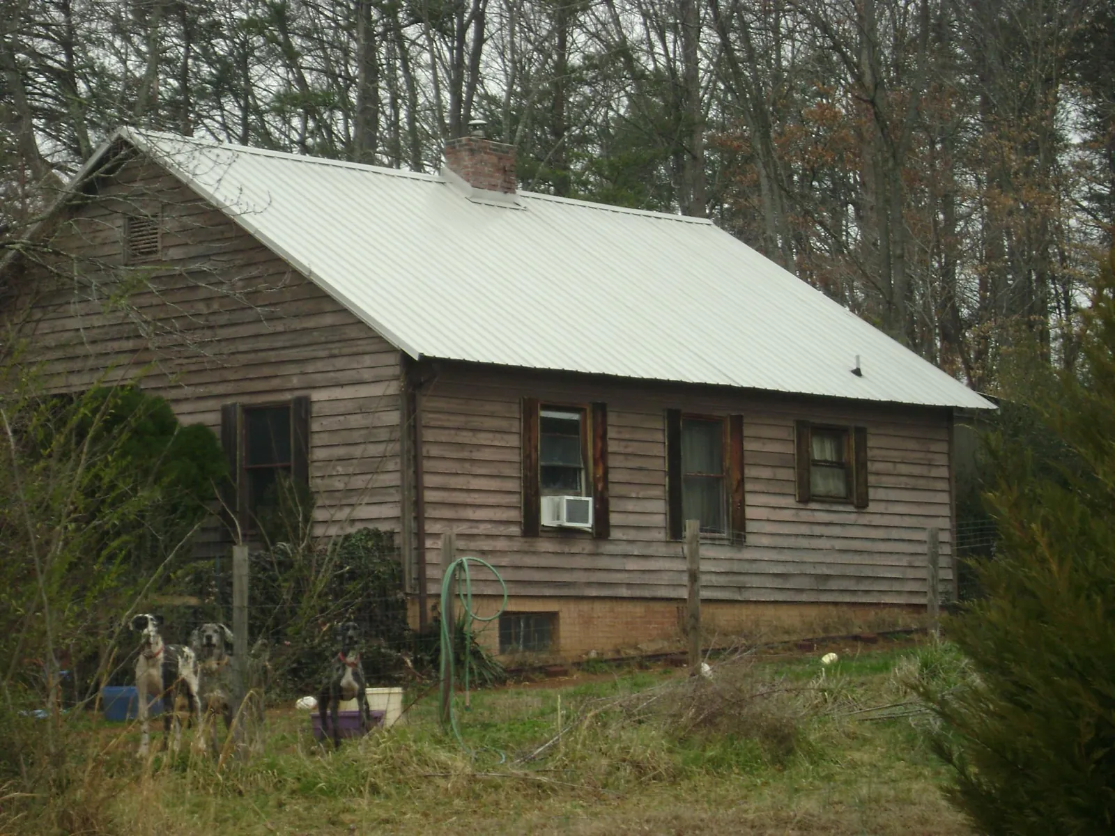 White metal roof on an old wood sided farmhouse, from a Metal Roof Installation job in Elkridge